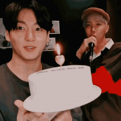 Man Holding White Cake With Candle