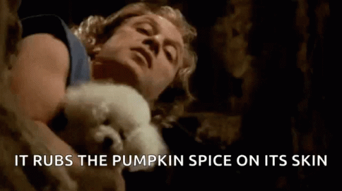 Man Holding White Dog It Rubs The Pumpkin Spice On Its Skin