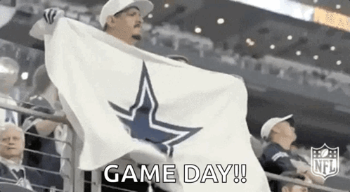 Man Holding White Flag With Cowboy Star in Stadium