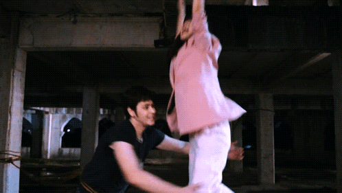 Man Holding Woman In Dark Room GIF