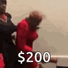 Man Holding Woman In Red Dress Says $200 With Man Behind GIF