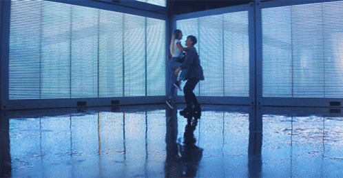 Man Holding Woman in Room With Windows