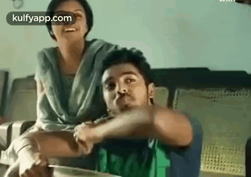 Man Holding Woman's Arm On Couch GIF