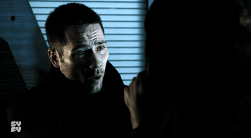 Man Holding Woman's Hand In Front Of TV Saying Su Fy GIF