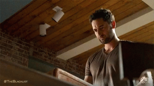 Man Holding Wood with Brick Wall and Wooden Ceiling