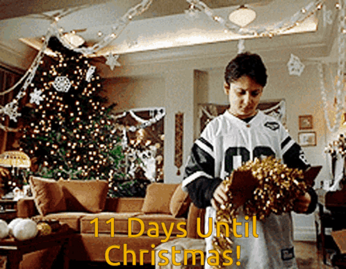 Man Holding Wreath in Front of Christmas Tree Saying 11 Days Until Christmas