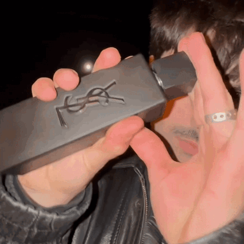Man Holding YSL Perfume Bottle