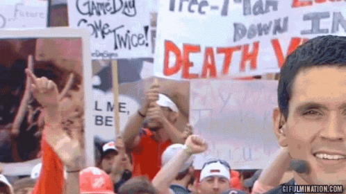 Man Holds Sign Saying Death