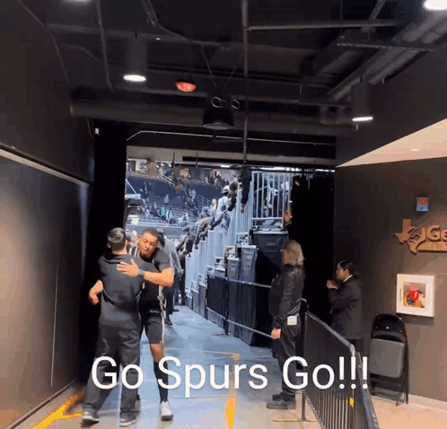 Man Hugging Another Man in Tunnel Go Spurs Go
