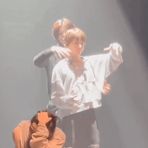 Man Hugging Another on Stage