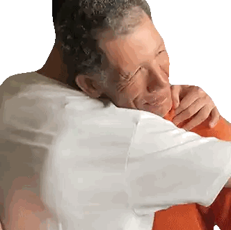 Man Hugging Man in Red Shirt
