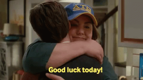 Man Hugging Woman in Blue Hat