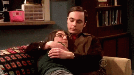 Man Hugging Woman On Couch GIF