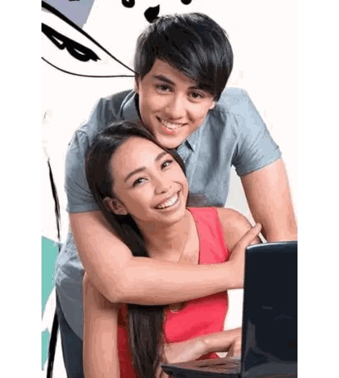 Man Hugging Woman Using Laptop