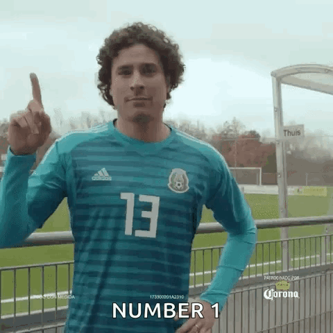 Man in #13 Jersey Pointing Up