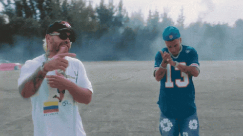 Man in 15 Jersey Beside White Shirt Man