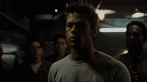 Man In A Shirt In Dark Room GIF