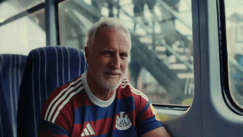 Man in Adidas Shirt Sitting
