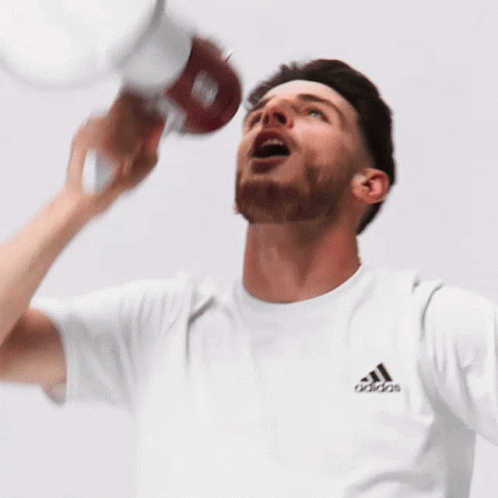 Man in Adidas T-Shirt Holding Bottle