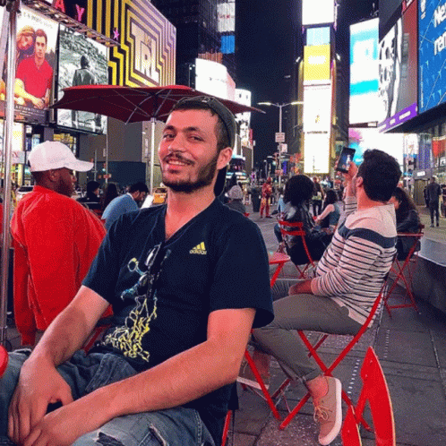 Man in Adidas T-Shirt on Red Chair at Star Sign