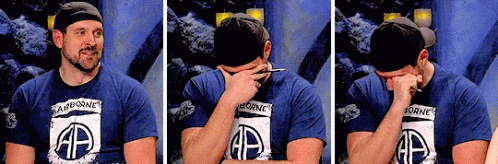 Man in Airborne Shirt Covering Face