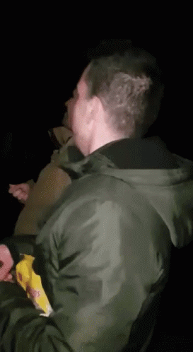 Man in Airborne Shirt Covering Face