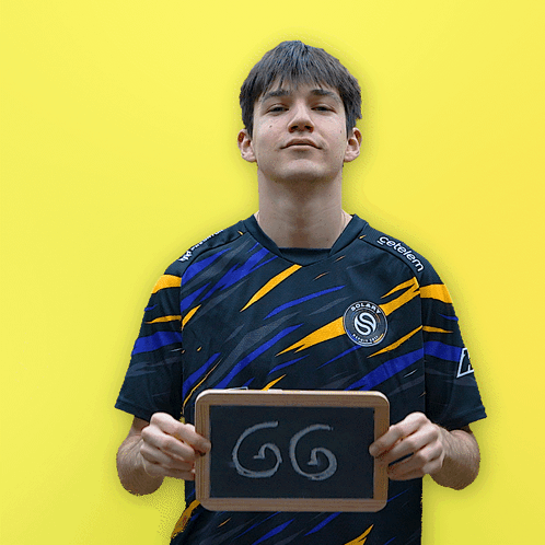 Man in Aldi Shirt Holding GG Sign