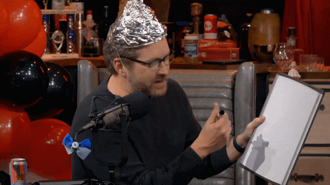 Man in Aluminum Foil Hat Holding Book