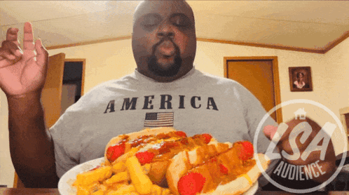 Man in America Shirt Eating Hot Dog