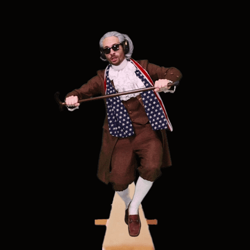 Man in American Flag Outfit Holding Cane and Hammer