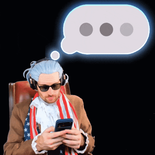 Man in American Flag Scarf and Headphones Looking at Phone