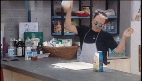 Man In Apron And Sunglasses Throwing A Ball GIF