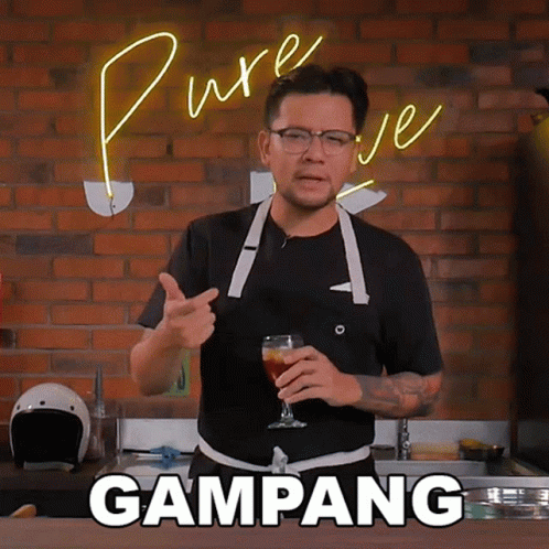Man in Apron Holding Beer With Gampang