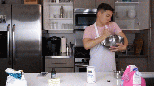Man In Apron Mixing With Baking Powder GIF