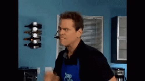 Man in Apron Saying Sap Clean in Kitchen