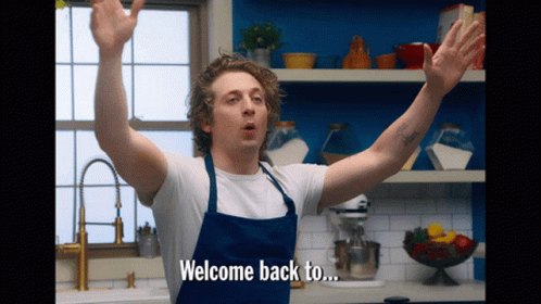 Man in Apron Says Welcome Back To