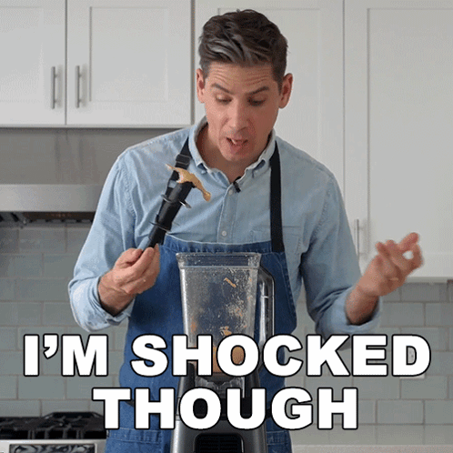 Man in Apron Shocked at Blender