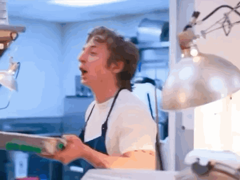 Man in Apron Standing in Kitchen