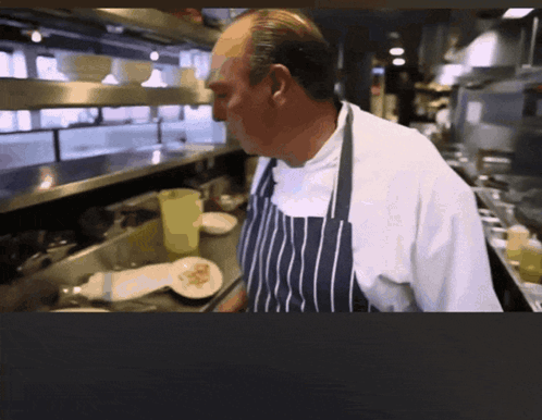 Man in Apron Standing in Kitchen