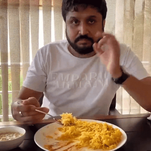 Man in Armani Shirt Eating Food