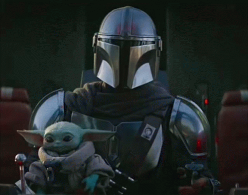 Man in Armor Holding Baby Yoda