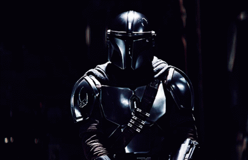 Man in Armor Holding Lightsaber