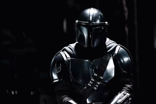 Man in Armor Holding Lightsaber