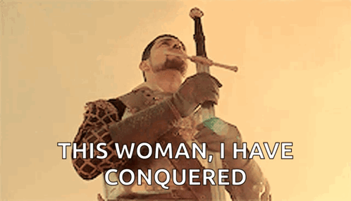 Man in Armor Holding Sword in Mouth