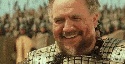 Man in Armor Smiling Before Soldiers