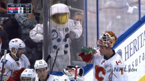 Man In Astronaut Costume Drinking Green Bottle GIF