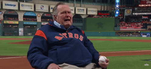 Man in Astros Jacket Holding Baseball