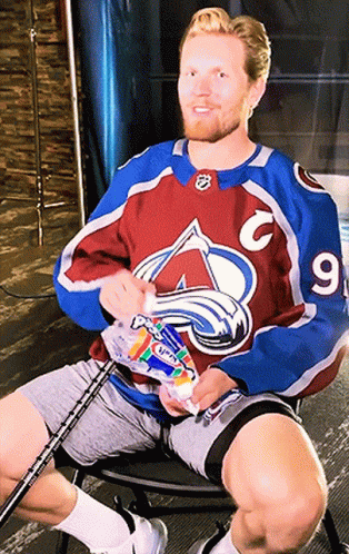 Man in Avalanche Jersey Holding Toothpaste