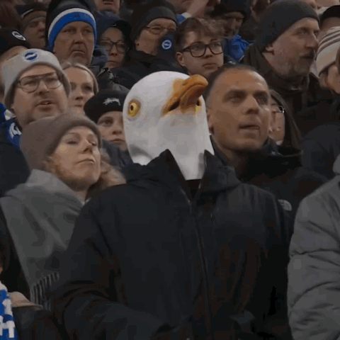 Man in Bald Eagle Mask in Crowd