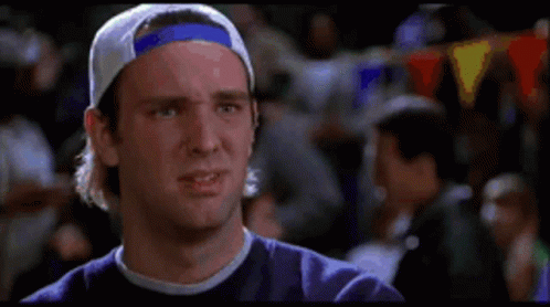 Man in Baseball Cap and Purple Shirt Making a Face